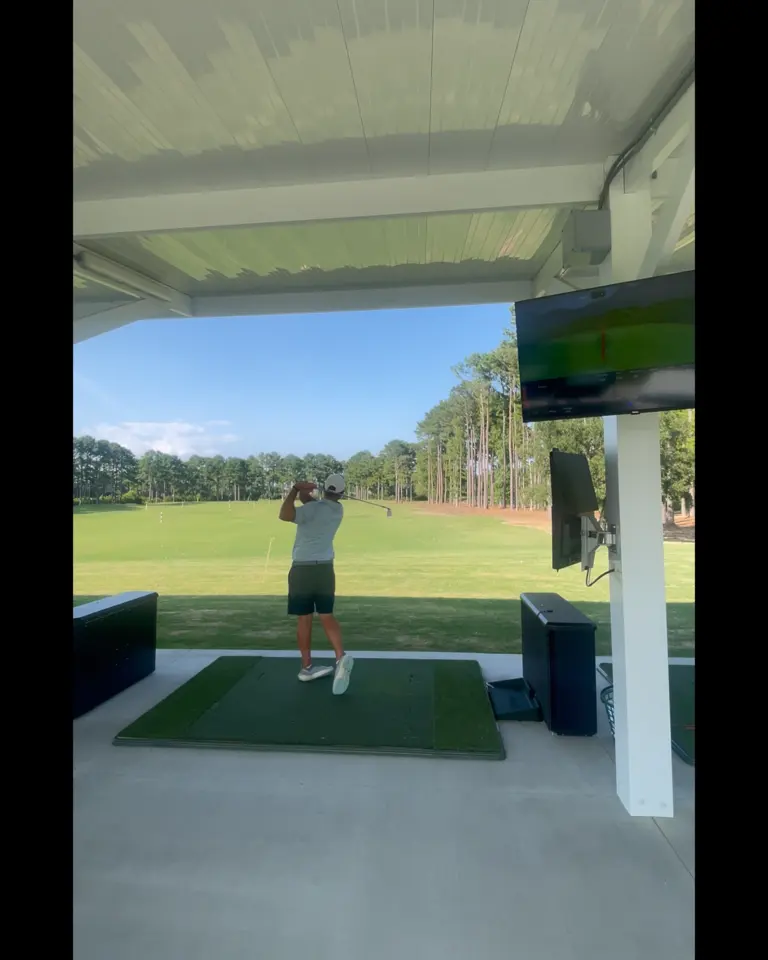 Golfer practicing at the TopTracer Range at World Tour Golf Links